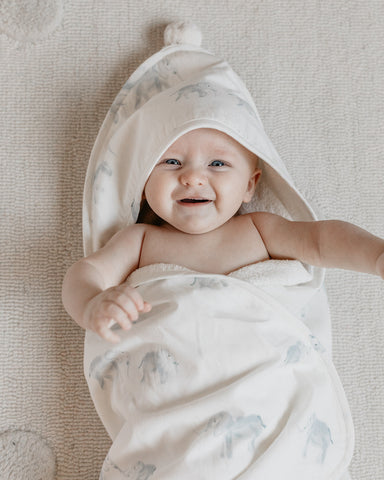 baby wearing hooded towel after bath