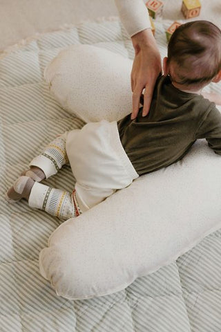 baby using pillow for tummy time