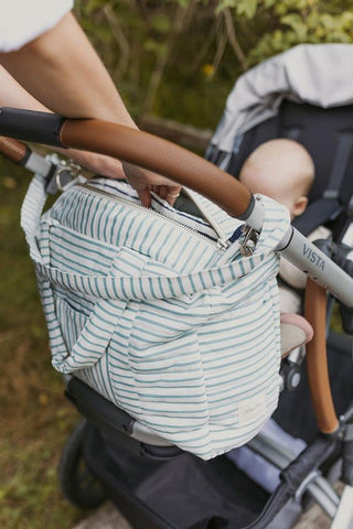striped diaper bag attached to baby stroller