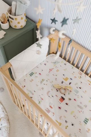 crib with mobile hanging above