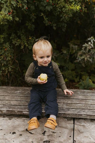 baby in overalls 