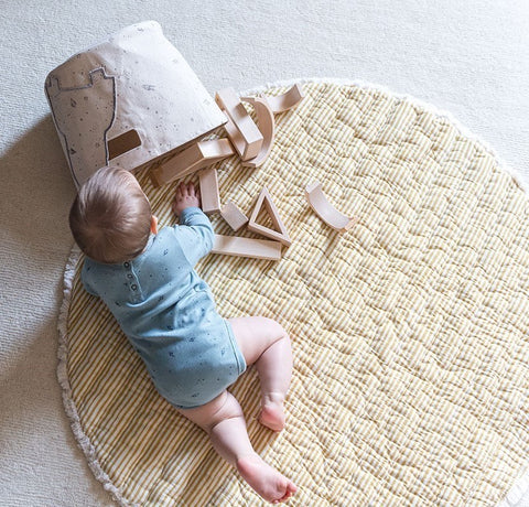 baby playing with toys on play mat