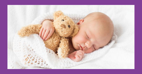 Baby holding teddy bear