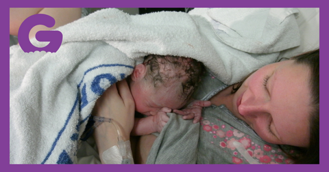 A mother who has just given birth, baby lying on her chest.