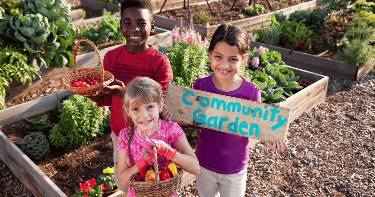 Children holding a community garden sign.