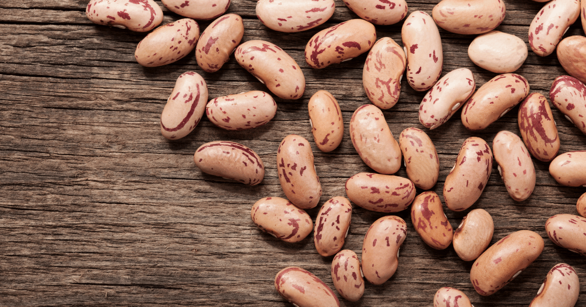 Pinto beans on a wood table