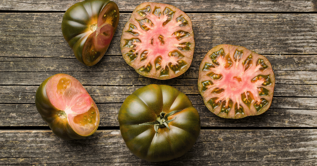 Dark brandywine tomatoes on old wooden table