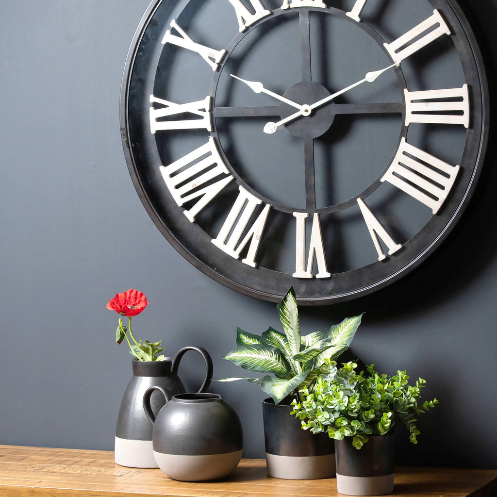 Black Framed Skeleton Wall Clock With White Roman Numerals