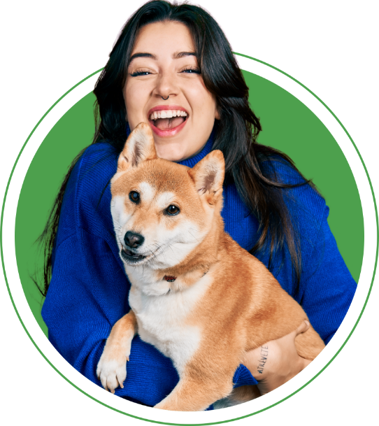 Woman smiling holding a dog