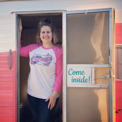 Hawkeye Screen Printing owner Allison Rose standing in here mobile shop"Shirley the Shirt Shack"