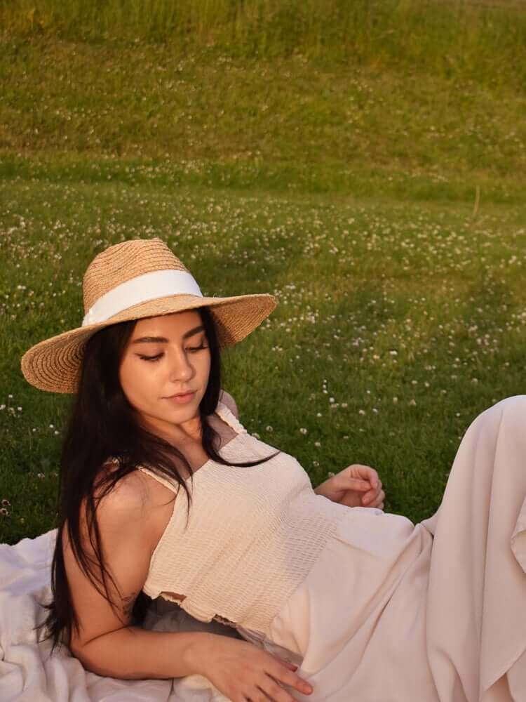 Women with hat in honeymoon travel outfit