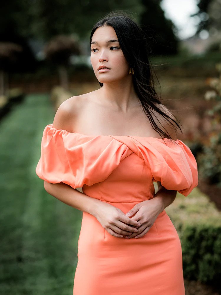 model wearing an orange dress