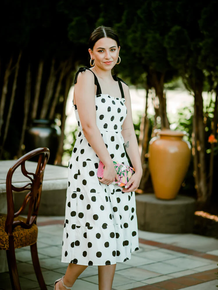 model wearing a polka dot midi dress