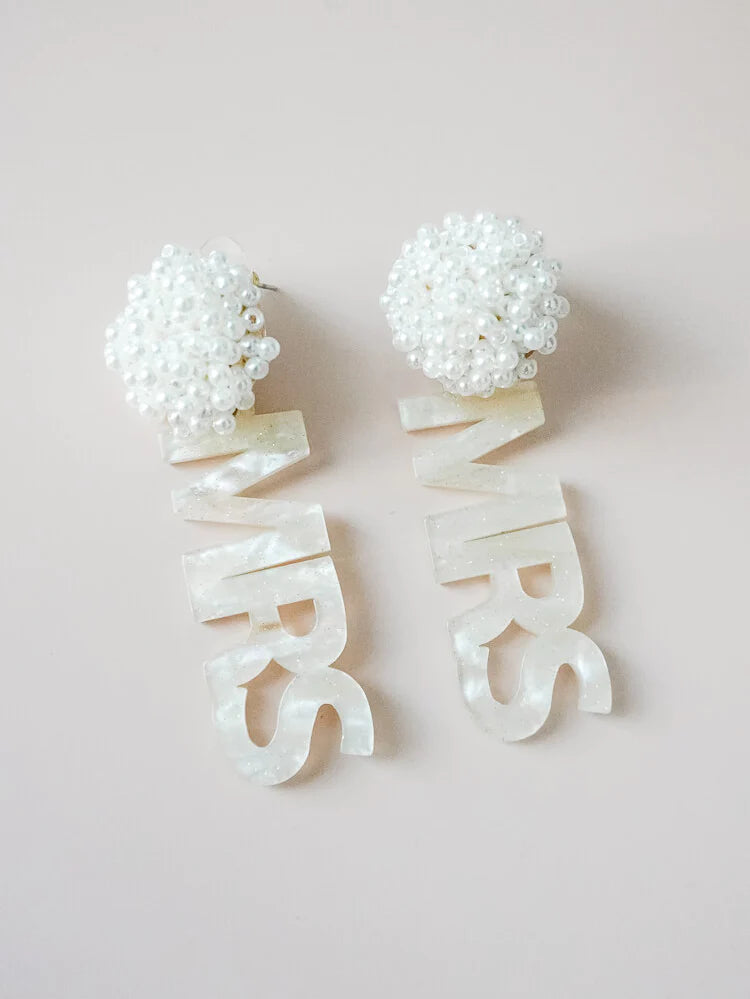 a pair of white acrylic “Mrs.” dangle earrings