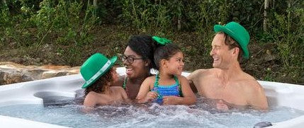 family in hot tub enjoying st patricks day decorations