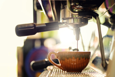 Fresh coffee being poured from a coffee machine into a mug in Dewalden's Garden Centre coffee shop with idyllic background