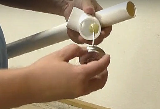 Apply a layer of PVC cement inside the fitting and outside the PVC pipe.