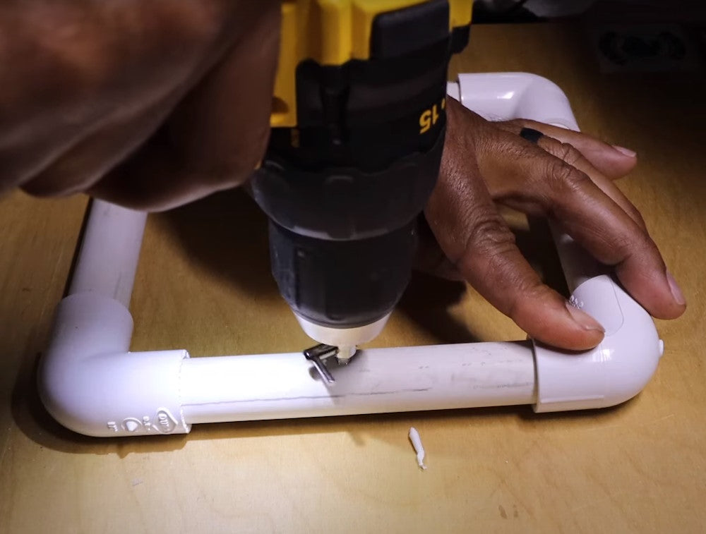 Drill the metal air valve into the PVC loop