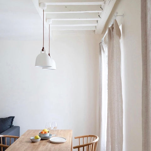 White dining room with wooden table.