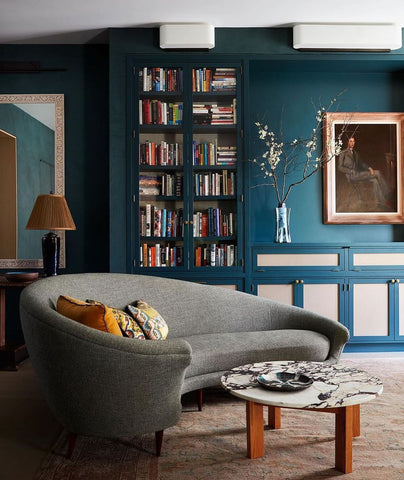 Ling room with bookshelves and large grey couch 