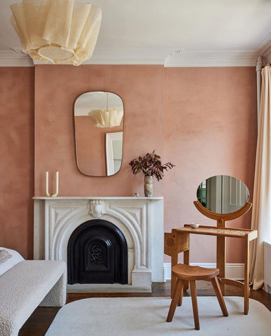 Room with pink walls and fireplace