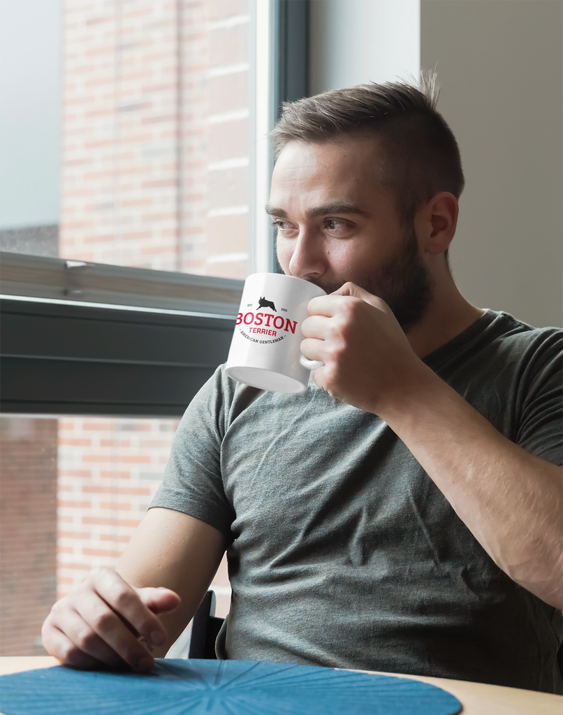 A man holding a Boston Terrier mug