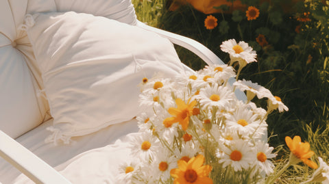 Bed surrounded by a field of daisies, symbolizing the concept of airing pillows in the sun for freshness and cleanliness