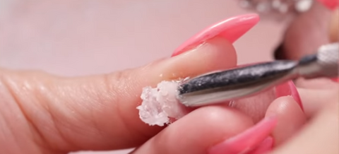 using a cuticle pusher to remove acrylic nails