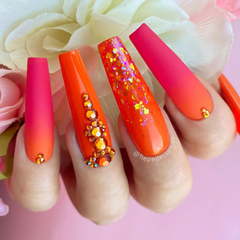orange and red nails with rhinestones