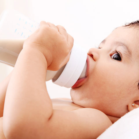 baby drinking out of a bottle