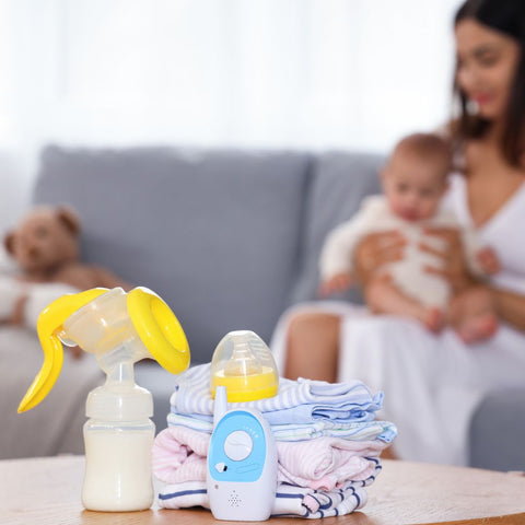 mom on couch with babies and breast pump on table