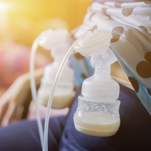 woman using double-electric breast pump