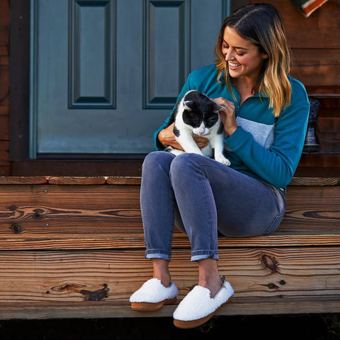 Woman sitting on wooden stairs wearing the Acorn Bristol Moccasin.