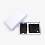 A corporate logo branded Lacoste wallet set in a gift box set against a white background