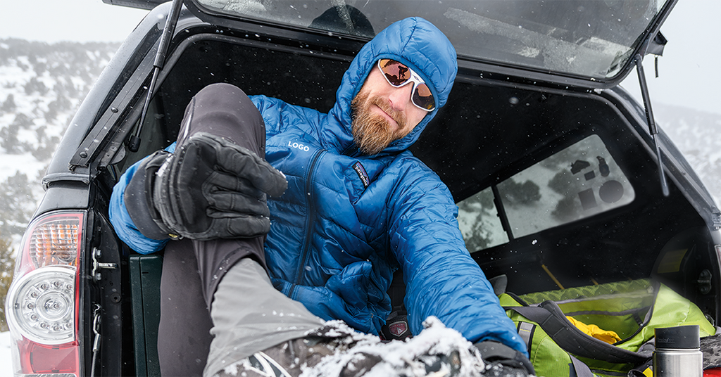 Patagonia Jacket on Mountain Climber Putting on Crampons