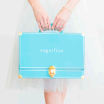 A pretty custom logo printed candy box is held by a woman