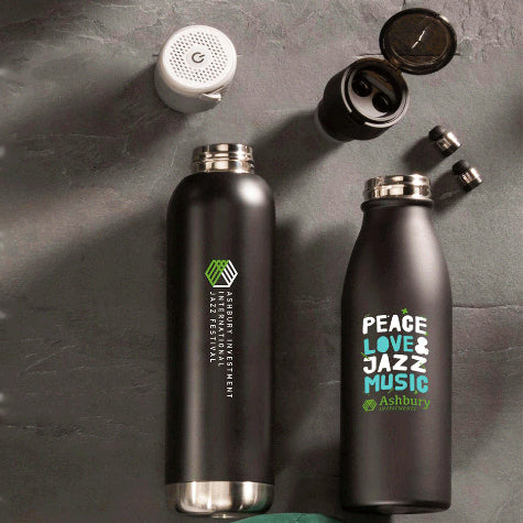 Two custom logo branded Leeds water bottles laying on a black background with two bottle lids sitting above them