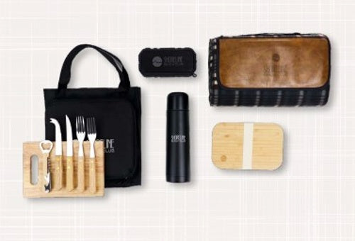 The logo-branded cutlery set, a logo-embroidered company blanket, a custom water bottle, and more set in front of a white background