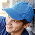 A man in a corporate logo embroidered baseball cap smiling