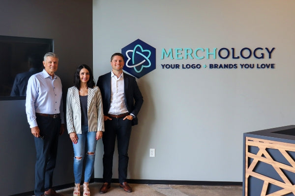 The Merchology executive team in the new Merchology HQ entryway