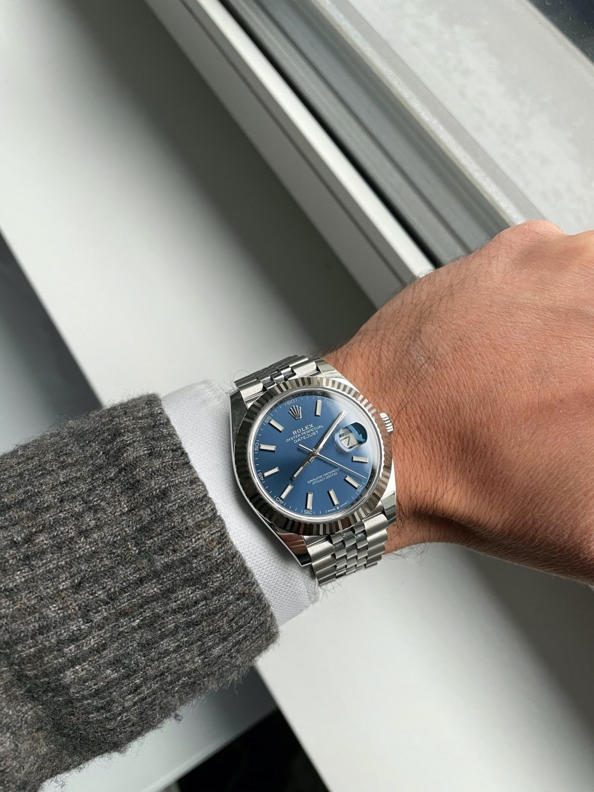 rolex datejust on with blue dial on wrist