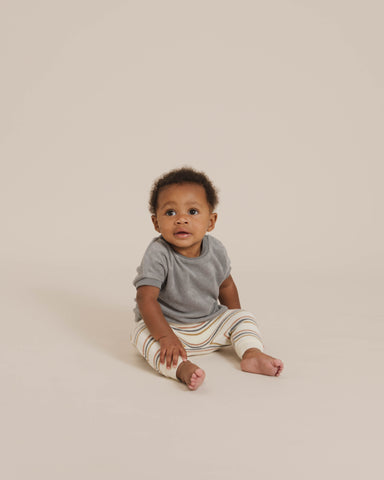 Quincy Mae Spring Summer 21 Drop 2 - older baby sitting up in a studio shoot wearing the terry cloth tee in ocean with the retro stripe terry sweatpants