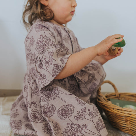 Toddler wearing the Buck & Baa Peony Bell Sleeve Dress with a close up of how the bell sleeve lays on the arm. 