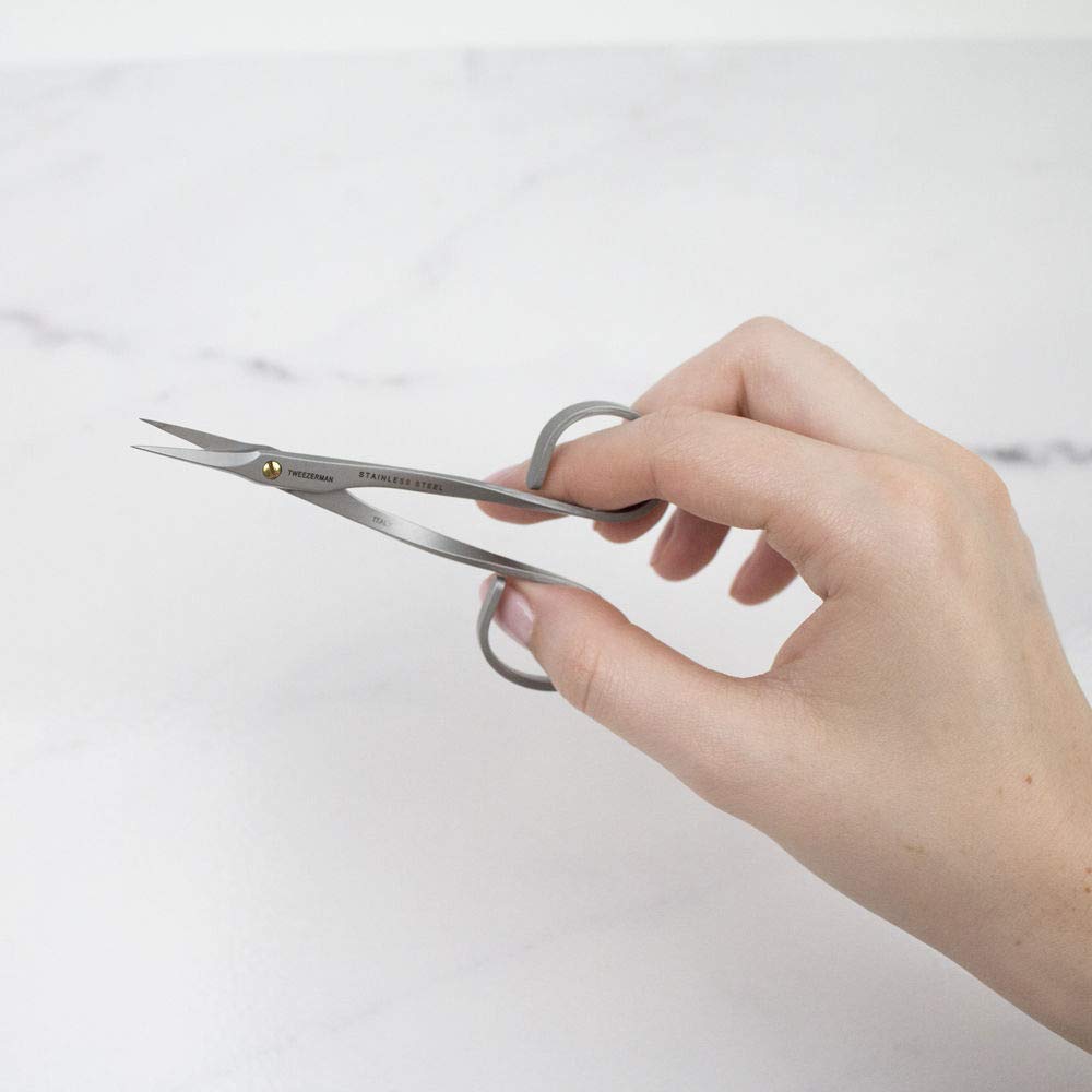 The scissors are also designed with a comfortable grip, allowing users to hold them with ease and use them for extended periods without experiencing any discomfort. The design of the scissors also features a curved shape that helps users to work with natural cuticle curves.