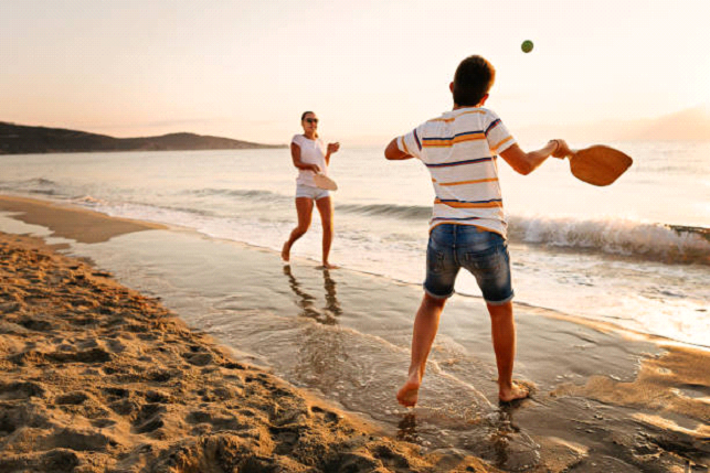 playing tennis at the beach