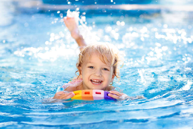 kids on floatee in pool