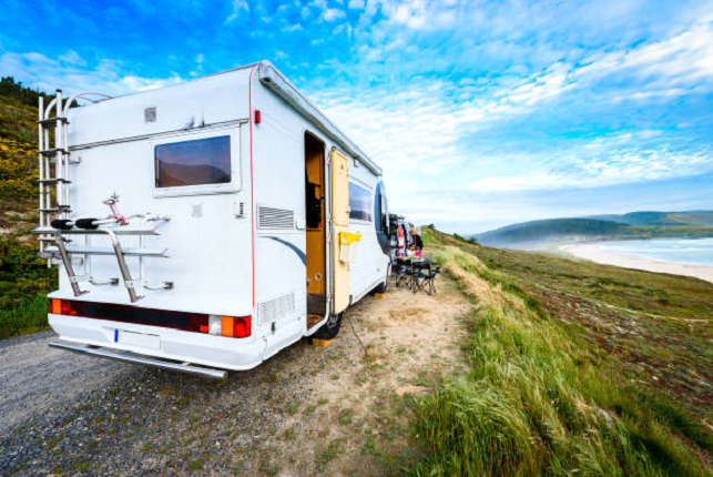 caravan rv next to the ocean