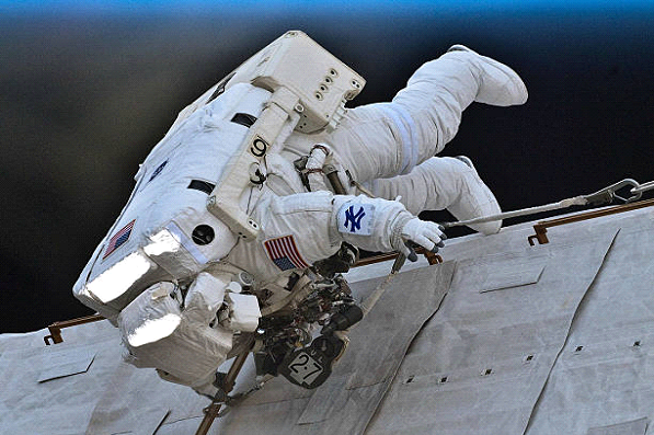 astronaut working on space shuttle