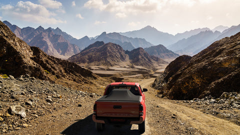 red toyota tacoma with sawtooth tonneau cover