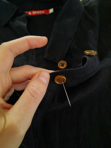 Threading needle through remaining button holes